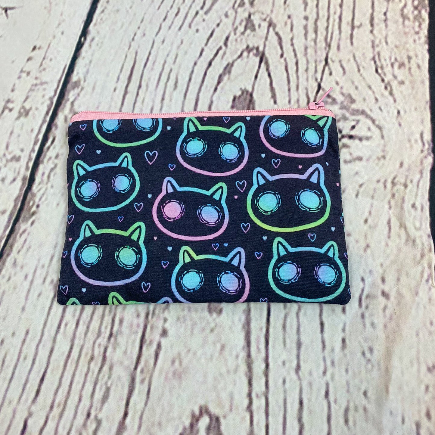 a small pouch with a cat pattern on it