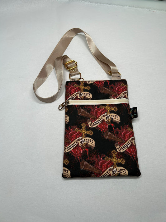 A handbag with a pattern of red and black hearts and the text "Vampire Slayer" printed on it.