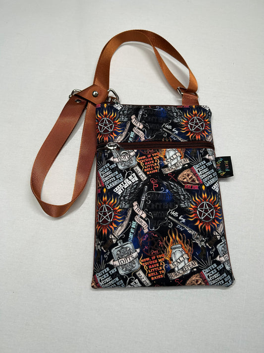 A colorful, patterned handbag with various graphic designs and text printed on it.
