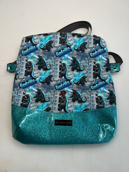 Godzilla Themed foldover crossbody bag with blue glitter bottom