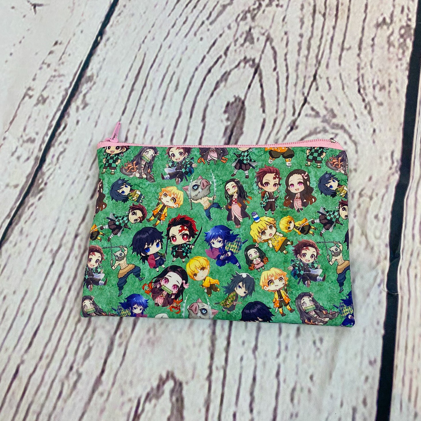 a small pouch with a pattern of cartoon characters on it