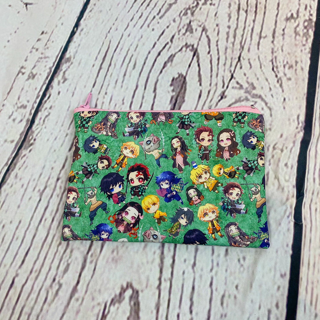 a small pouch with a pattern of cartoon characters on it