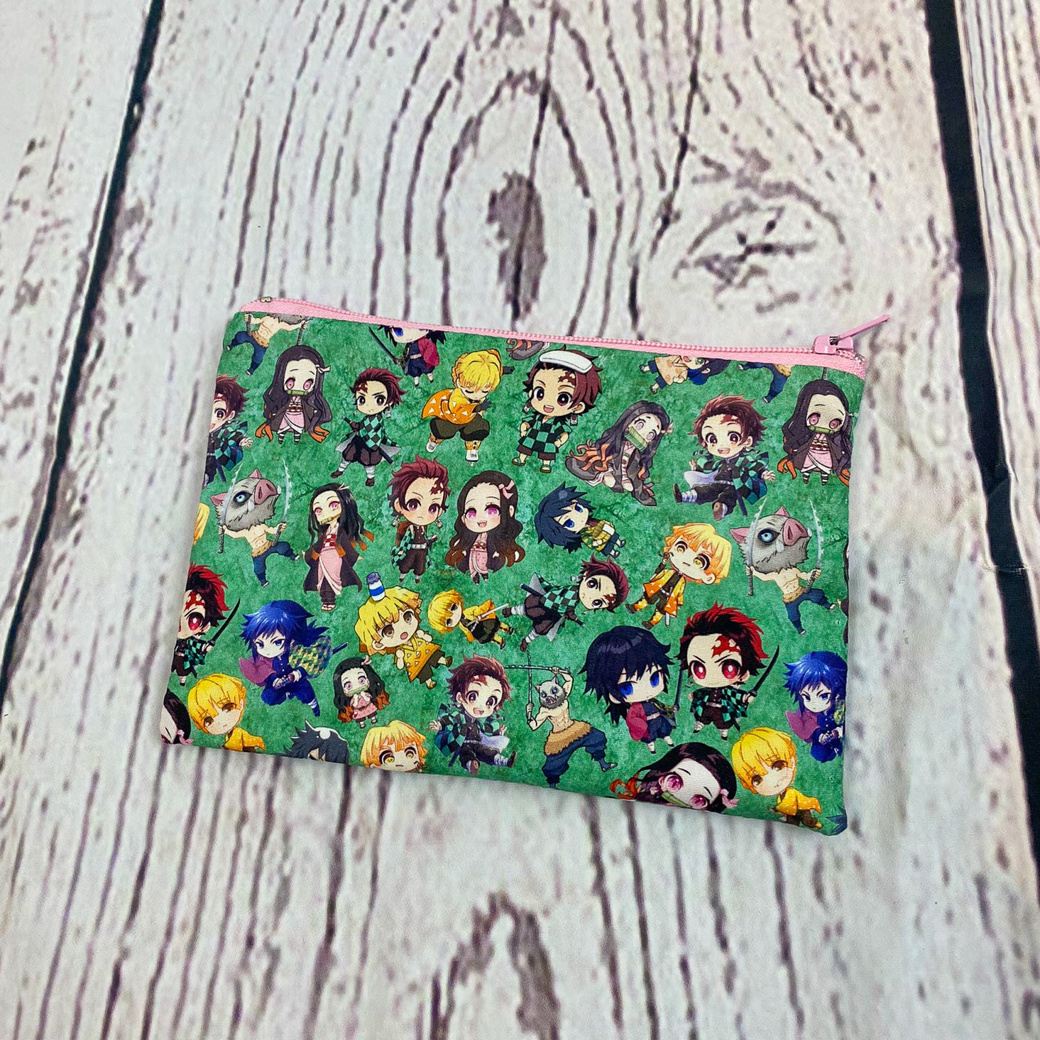 a green bag with a bunch of cartoon characters on it