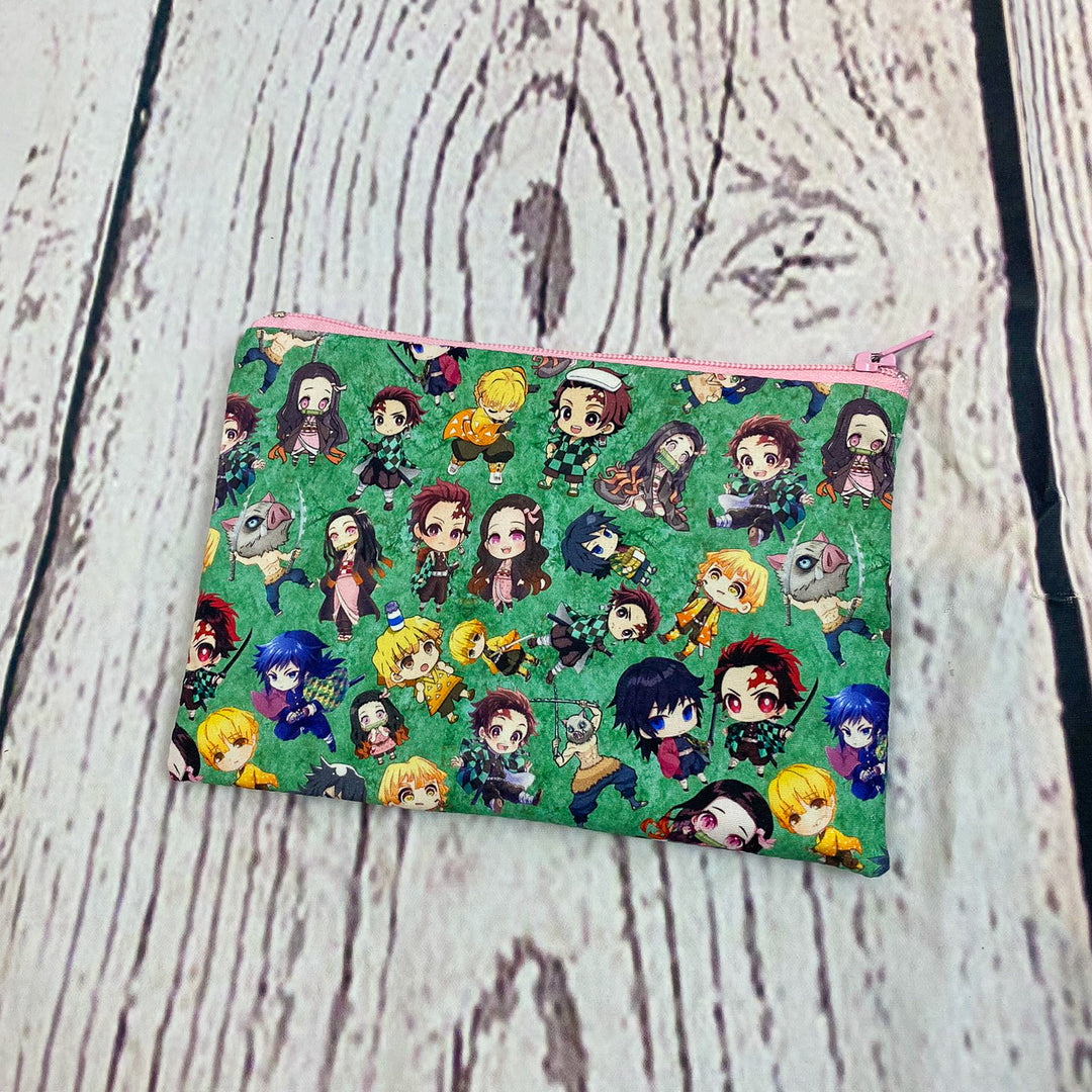 a green bag with a bunch of cartoon characters on it