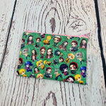 Load image into Gallery viewer, a green bag with a bunch of cartoon characters on it
